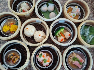 A selection of assorted dim sum dishes served in bamboo steamers.