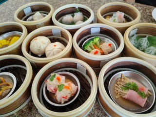 A selection of assorted dim sum dishes served in bamboo steamers.