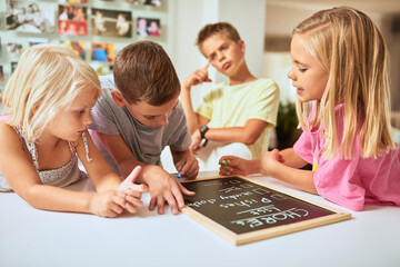 Kids, writing and chalkboard for chores, list and group for teaching, help or development in family house. Children, blackboard or notes for siblings, schedule or planning for cleaning with hygiene