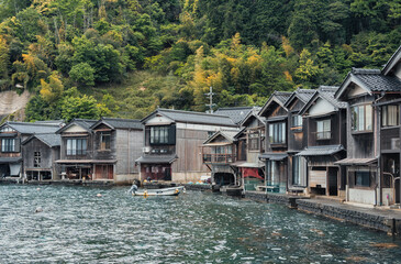 Beautiful scenic view with the wooden traditional waterfront boat houses called funaya around Ine...