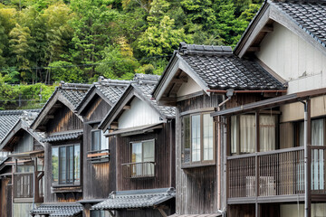 Close up detail wtith the wooden traditional waterfront boat houses called funaya around Ine Bay, in the village Ine, Japan