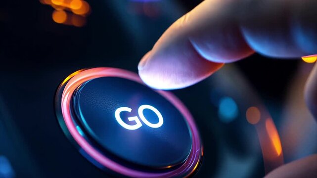 Macro close up of a finger tip tapping a circular purple and blue glowing "GO" button on a black colored electronics panel.