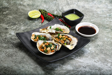 Open half oysters with green onion