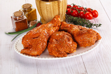 Raw turkey shoulder wing in Indian tandoori marinade