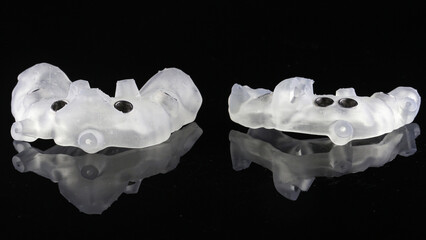 two surgical templates for total implantation on black glass wit