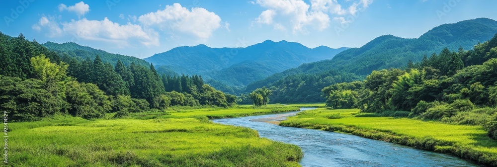 Poster Serene River Winding Through Lush Green Valley And Mountain Landscape - A serene river meanders through a lush green valley, surrounded by majestic mountains and a vibrant sky, symbolizing tranquility