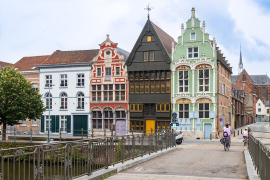 Historic canal houses with the Devil's House - De Duiveltjes, with wooden facade and Het Paradijs on the left in Mechelen.