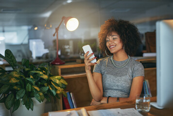 Night, creative and woman at desk with phone, smile and search on social media website for networking. Smartphone, scroll and designer on mobile app for article, email or online chat in dark office
