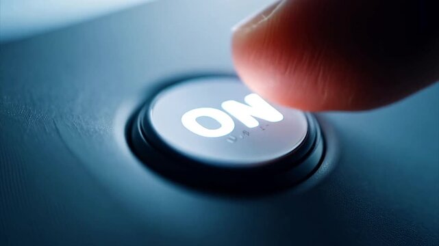 Macro shot of finger pressing an "ON" button on an electronics panel.