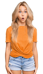 Young blonde girl wearing casual clothes scared and amazed with open mouth for surprise, disbelief face