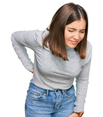 Young beautiful woman wearing casual turtleneck sweater suffering of backache, touching back with hand, muscular pain