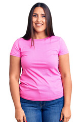 Young beautiful brunette woman wearing casual t-shirt looking positive and happy standing and smiling with a confident smile showing teeth