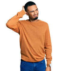 Young african american man wearing casual clothes confuse and wondering about question. uncertain...