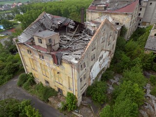 Historic old Early 20th century cupid decorated brick ruined derelict abandoned apartment house building facade