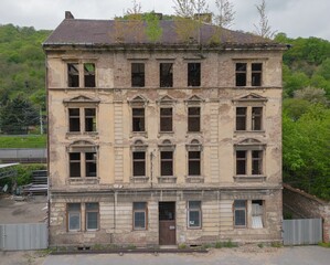 Historic old Early 20th century cupid decorated brick ruined derelict abandoned apartment house building facade