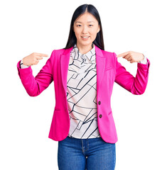 Young beautiful chinese woman wearing elegant clothes looking confident with smile on face,...