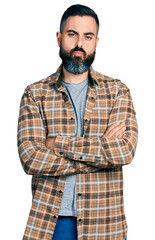 Hispanic man with beard with arms crossed gesture looking at the camera blowing a kiss being lovely and sexy. love expression.