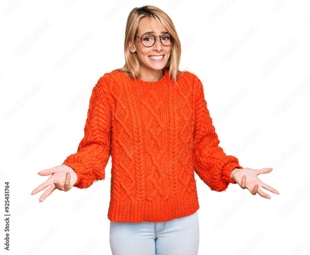 Wall mural Beautiful blonde woman wearing casual clothes and glasses smiling cheerful with open arms as friendly welcome, positive and confident greetings