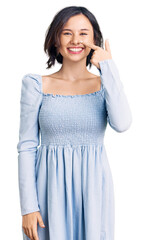 Fototapeta premium Young beautiful girl wearing casual clothes pointing with hand finger to face and nose, smiling cheerful. beauty concept