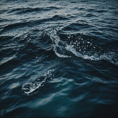 Naklejka premium Gentle waves lapping against a quiet, sandy beach with a picturesque sunset in the background