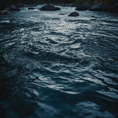 Soft waves creating a serene pattern on the surface of a calm bay with clear skies above