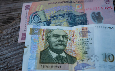 Romanian leu and Bulgarian lev on wooden background. 