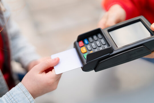 Person Using Card Reader to Process  Payment Outdoors During Daylight