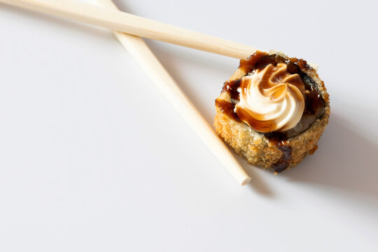 Hot holl with chopsticks on a white background photographed from top to bottom