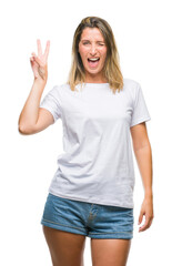 Young beautiful woman over isolated background smiling with happy face winking at the camera doing victory sign. Number two.