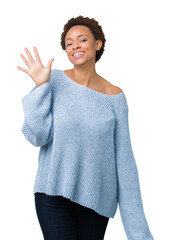 Young beautiful african american woman wearing a sweater over isolated background showing and pointing up with fingers number five while smiling confident and happy.