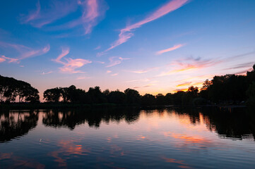 Beautiful reflections of pink colored clouds in a lake