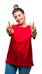 Young beautiful woman over isolated background smiling looking to the camera showing fingers doing victory sign. Number two.