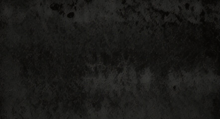 Fototapeta premium Black background made of real, shiny black paper covered with foil, illuminated by a soft light from above. 
