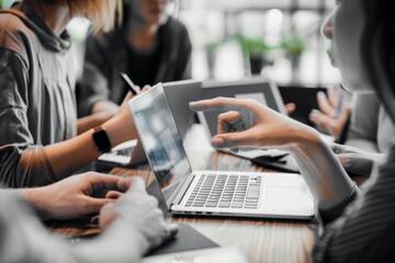 Young Business Team Collaborating Over Laptop in Coffee Shop, Close-Up of Hands on MacBook, Black-and-White High-Contrast Photography with Copy Space