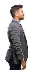 Young handsome business man over isolated background looking to side, relax profile pose with natural face with confident smile.