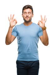 Naklejka premium Young handsome man over isolated background relax and smiling with eyes closed doing meditation gesture with fingers. Yoga concept.