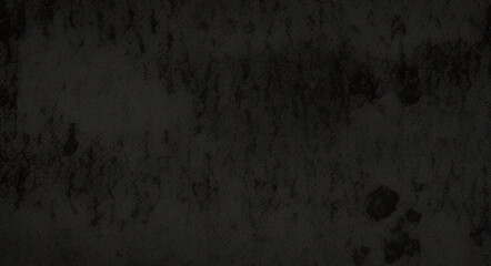 Black background made of real, shiny black paper covered with foil, illuminated by a soft light from above.	