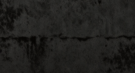 Obraz premium Black background made of real, shiny black paper covered with foil, illuminated by a soft light from above. 