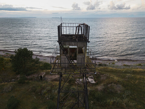 An old Soviet border tower in Neeme against a cloudy sky. Drone view.