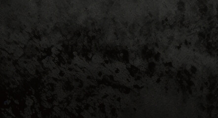 Black background made of real, shiny black paper covered with foil, illuminated by a soft light from above.	