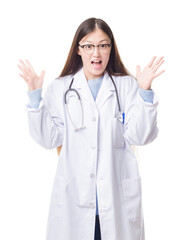 Fototapeta premium Young Chinese doctor woman over isolated background celebrating crazy and amazed for success with arms raised and open eyes screaming excited. Winner concept