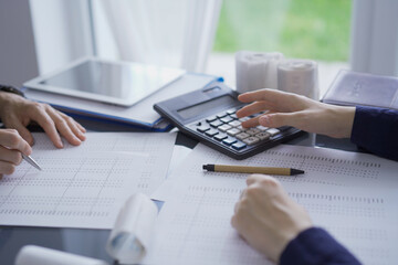 Female accountants or auditors reviewing financial data in office. Professionals analyzing paper...