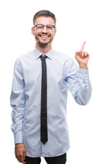 Young business man very happy pointing with hand and finger to the side