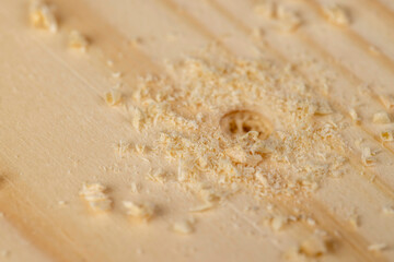 metal drill bit and pine wood board during operation