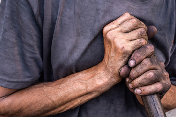 Dirty worker hands. Charcoal burner with dirty hands.