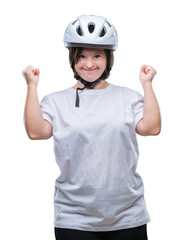 Young adult cyclist woman with down syndrome wearing safety helmet over isolated background celebrating surprised and amazed for success with arms raised and open eyes. Winner concept.