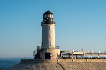 Modern elegant lighthouse in Lustica Bay in Montenegro. Adriatic coast on a sunny day. Marine landscape.