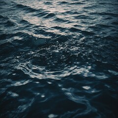 Naklejka premium The smooth, glistening surface of a serene lake reflecting the snow-capped mountains and a bright blue sky