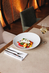 Greek salad on a large white plate. Restaurant food service, brunch, lunch, banquet.