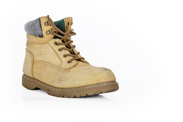 Single  vintage durable yellow leather hiking boot with laces in a worn look. One beige used military shoe with thick sole. Isolated on white background. Studio light. Copy space